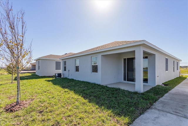 5017 Balsam Falls Rd, Deland, FL 32724 - rear view of property featuring cooling unit, stucco siding, a lawn, and a patio area