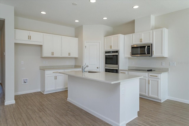5009 Balsam Falls Rd, Deland, FL 32724 - kitchen featuring stainless steel appliances, a sink, white cabinetry, and recessed lighting