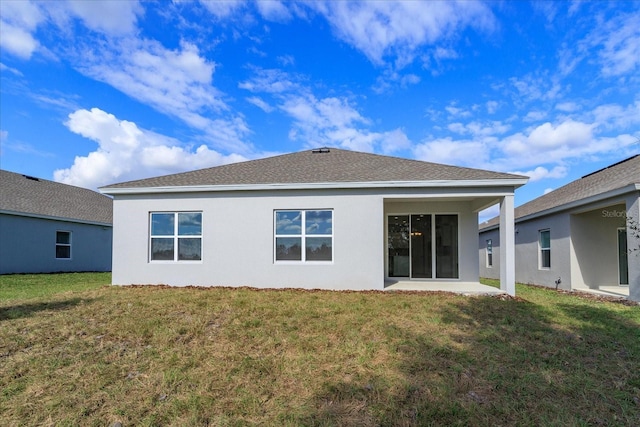 5009 Balsam Falls Rd, Deland, FL 32724 - back of property with stucco siding, a lawn, a patio area, and roof with shingles