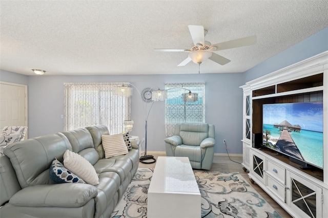 1728 Morelos Rd, The Villages, FL 32159 - living area featuring a textured ceiling, ceiling fan, and wood finished floors