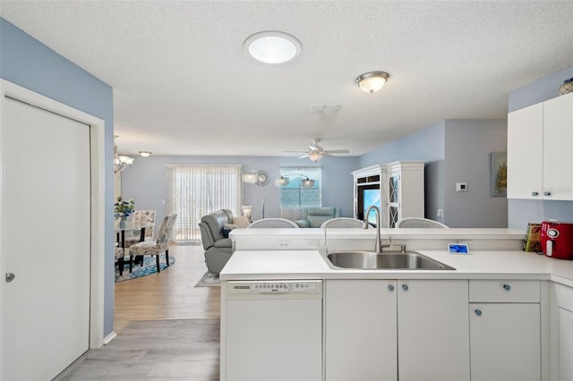 1728 Morelos Rd, The Villages, FL 32159 - kitchen with dishwasher, a sink, open floor plan, a peninsula, and ceiling fan