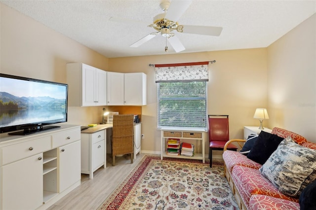 1728 Morelos Rd, The Villages, FL 32159 - living area with light wood-style floors, a ceiling fan, a desk, and baseboards