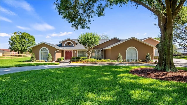 15245 Arabian Way, Montverde, FL 34756 - ranch-style house featuring stucco siding and a front yard