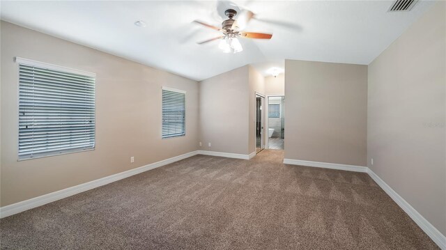 15245 Arabian Way, Montverde, FL 34756 - carpeted empty room with a ceiling fan, vaulted ceiling, baseboards, and healthy amount of natural light