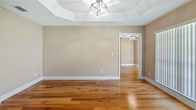 15245 Arabian Way, Montverde, FL 34756 - unfurnished room with a raised ceiling, light wood-type flooring, and baseboards