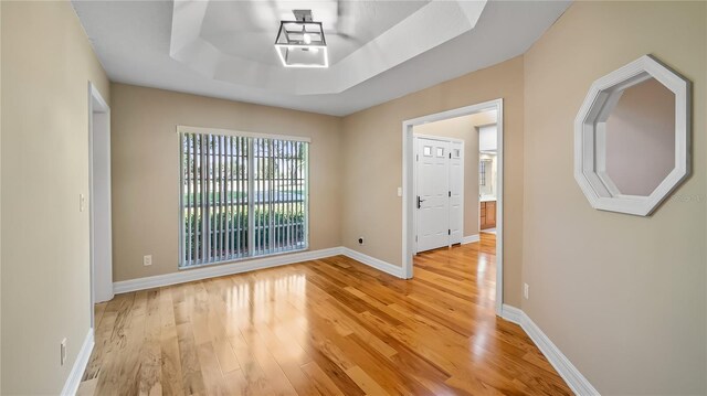15245 Arabian Way, Montverde, FL 34756 - empty room with light wood finished floors, baseboards, and a tray ceiling