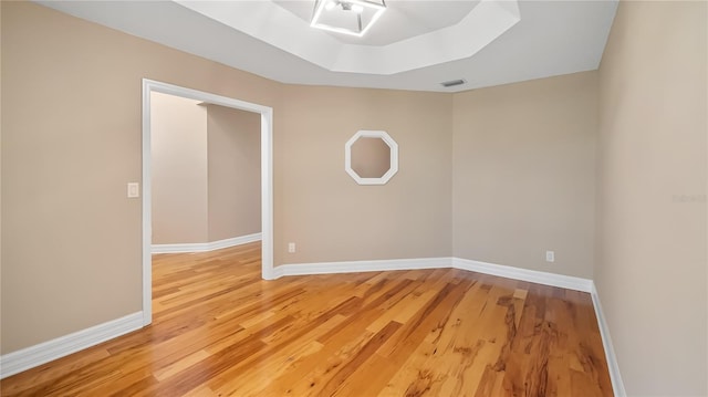 15245 Arabian Way, Montverde, FL 34756 - unfurnished room featuring light wood finished floors, baseboards, and a tray ceiling