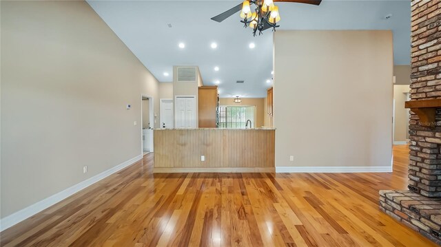 15245 Arabian Way, Montverde, FL 34756 - unfurnished living room featuring ceiling fan, light wood-style floors, baseboards, and high vaulted ceiling