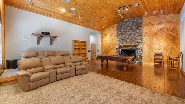 15245 Arabian Way, Montverde, FL 34756 - living area with track lighting, wood ceiling, wood-type flooring, wood walls, and a stone fireplace