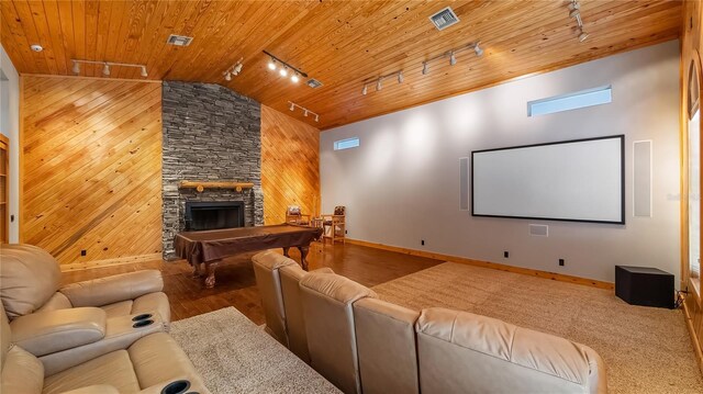 15245 Arabian Way, Montverde, FL 34756 - home theater room with track lighting, wood ceiling, wooden walls, a fireplace, and lofted ceiling