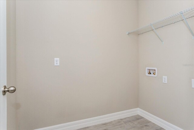 5036 Balsam Falls Rd, Deland, FL 32724 - washroom with hookup for a washing machine, baseboards, and light wood-style flooring