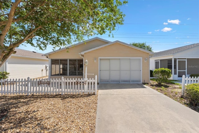 1615 Navidad St, The Villages, FL 32162 - ranch-style house featuring a sunroom, an attached garage, and driveway