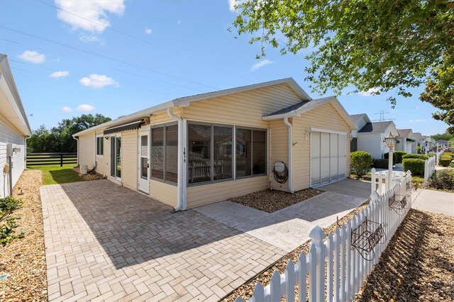 1615 Navidad St, The Villages, FL 32162 - rear view of house featuring a garage
