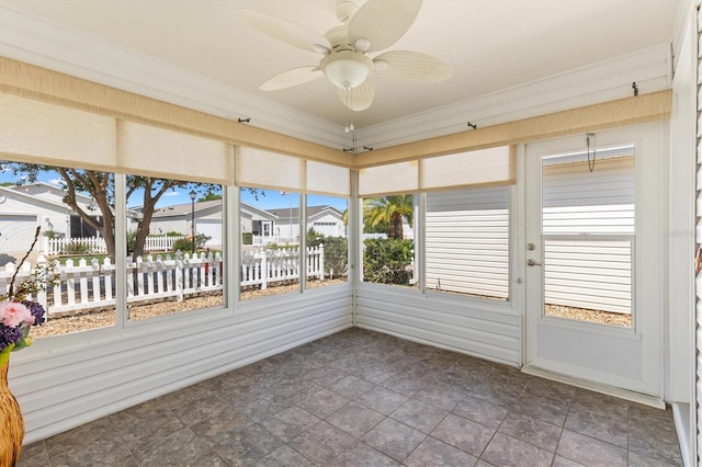 1615 Navidad St, The Villages, FL 32162 - unfurnished sunroom featuring a ceiling fan and a residential view