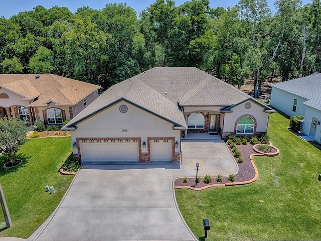 10994 SE 168th Loop, Summerfield, FL 34491 - view of front facade with stucco siding, concrete driveway, a garage, and a front lawn