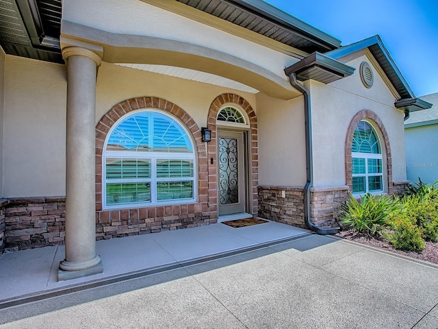 10994 SE 168th Loop, Summerfield, FL 34491 - view of exterior entry with stone siding and stucco siding