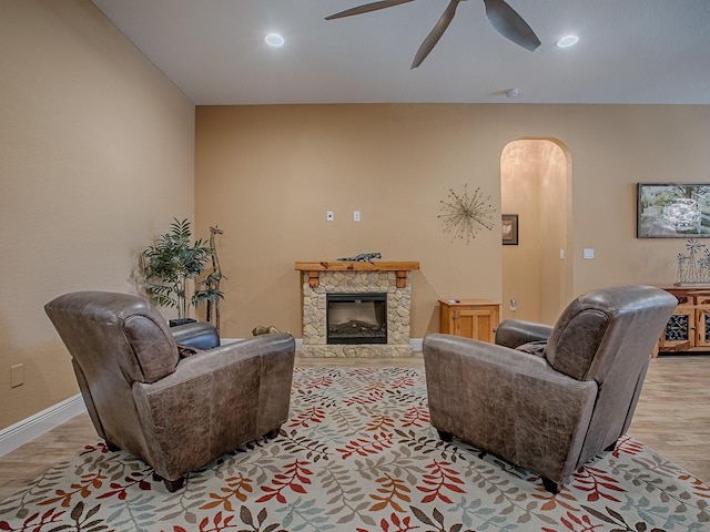 10994 SE 168th Loop, Summerfield, FL 34491 - living room with arched walkways, ceiling fan, wood finished floors, a fireplace, and recessed lighting