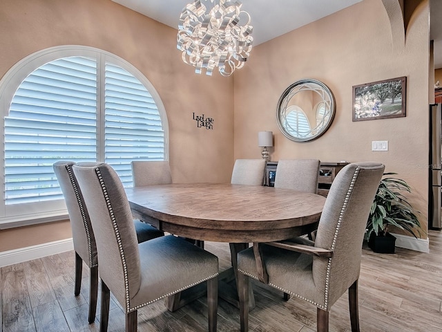 10994 SE 168th Loop, Summerfield, FL 34491 - dining area featuring a chandelier, baseboards, and wood finished floors