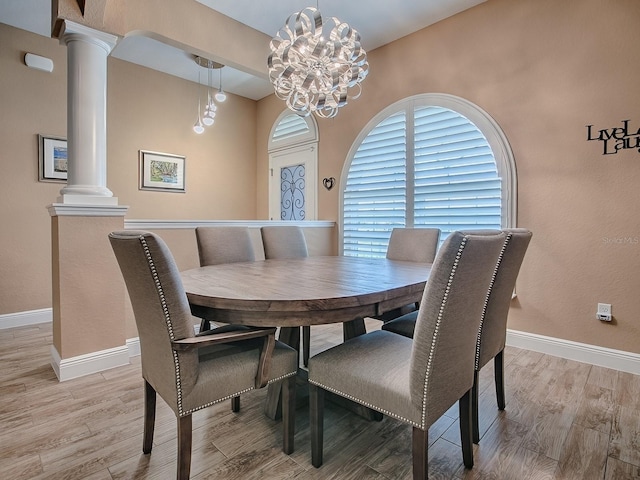 10994 SE 168th Loop, Summerfield, FL 34491 - dining area featuring ornate columns, light wood finished floors, and baseboards