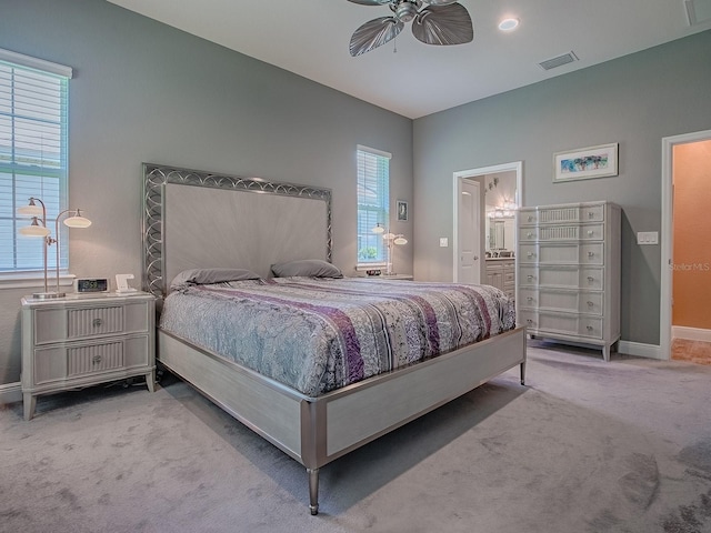 10994 SE 168th Loop, Summerfield, FL 34491 - carpeted bedroom with baseboards, a ceiling fan, and ensuite bathroom