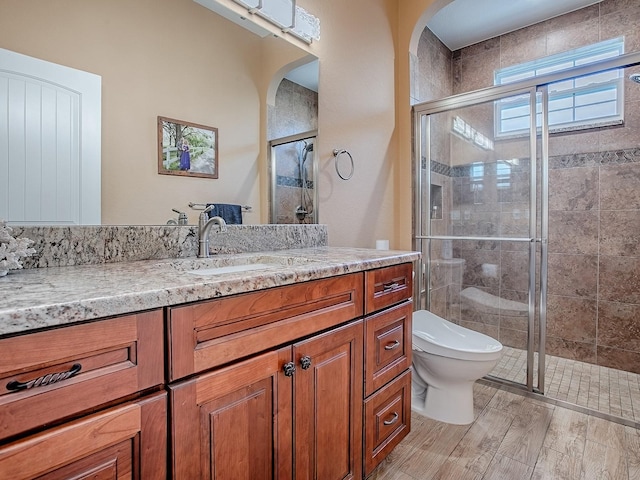 10994 SE 168th Loop, Summerfield, FL 34491 - bathroom with toilet, a shower stall, vanity, and wood finished floors