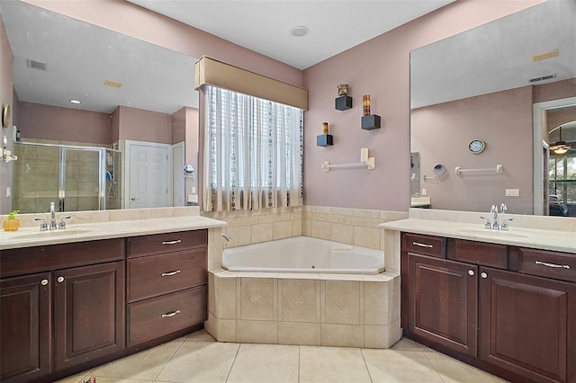 926 Wood Briar Loop, Sanford, FL 32771 - full bathroom featuring two vanities, a stall shower, a garden tub, and tile patterned floors