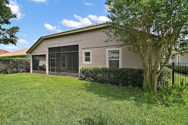 926 Wood Briar Loop, Sanford, FL 32771 - rear view of property featuring stucco siding and a sunroom