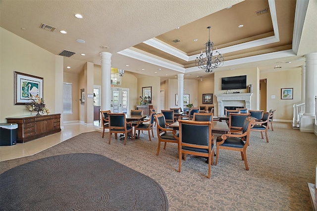 926 Wood Briar Loop, Sanford, FL 32771 - dining area featuring ornate columns, crown molding, a raised ceiling, light carpet, and a fireplace