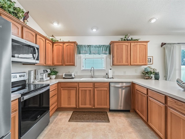 1713 Jadestone Ter, The Villages, FL 32162 - kitchen featuring stainless steel appliances, a sink, light countertops, recessed lighting, and a textured ceiling