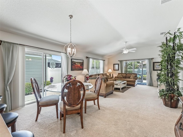 1713 Jadestone Ter, The Villages, FL 32162 - dining area featuring light colored carpet, ceiling fan, a chandelier, and lofted ceiling