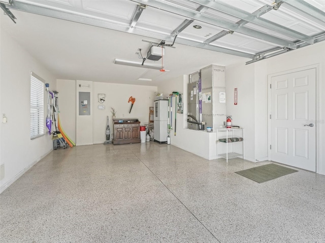 1713 Jadestone Ter, The Villages, FL 32162 - garage with electric panel, freestanding refrigerator, a garage door opener, and heating unit