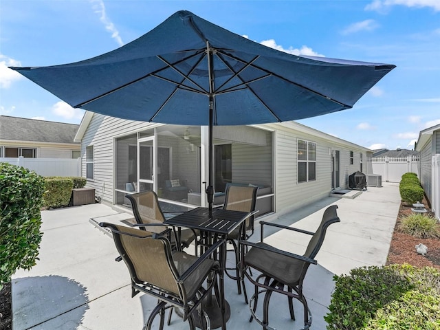 1713 Jadestone Ter, The Villages, FL 32162 - fenced backyard with a patio, outdoor dining space, and central AC