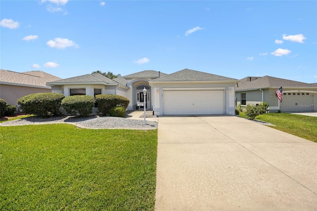 ranch-style home featuring an attached garage, a front yard, driveway, and stucco siding