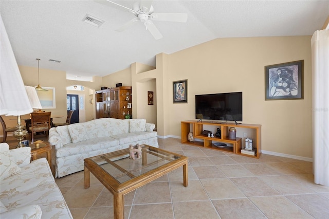 living area featuring arched walkways, a ceiling fan, lofted ceiling, light tile patterned floors, and baseboards
