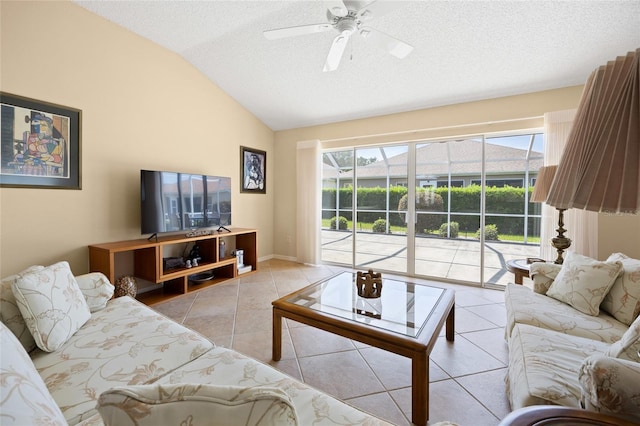 living area with vaulted ceiling, ceiling fan, light tile patterned flooring, a textured ceiling, and a sunroom