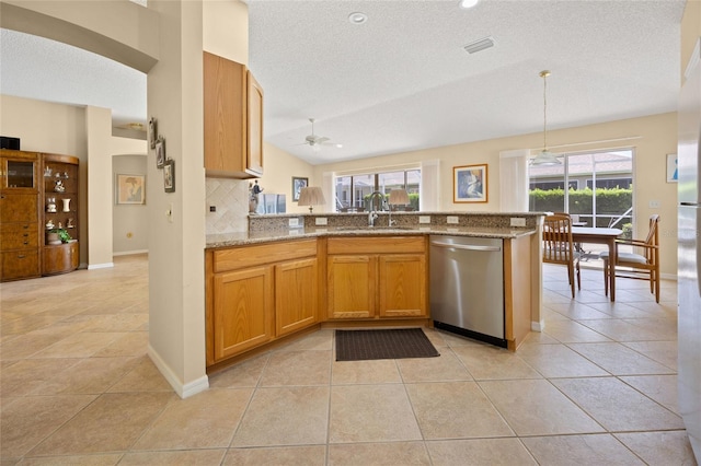 kitchen featuring dishwasher, a sink, stone counters, tasteful backsplash, and ceiling fan
