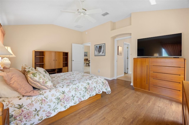 bedroom featuring vaulted ceiling, light wood finished floors, ceiling fan, and baseboards