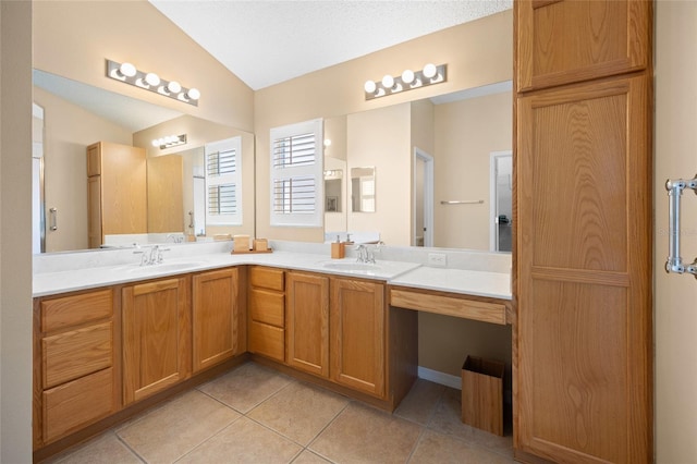 bathroom featuring tile patterned flooring, double vanity, and lofted ceiling