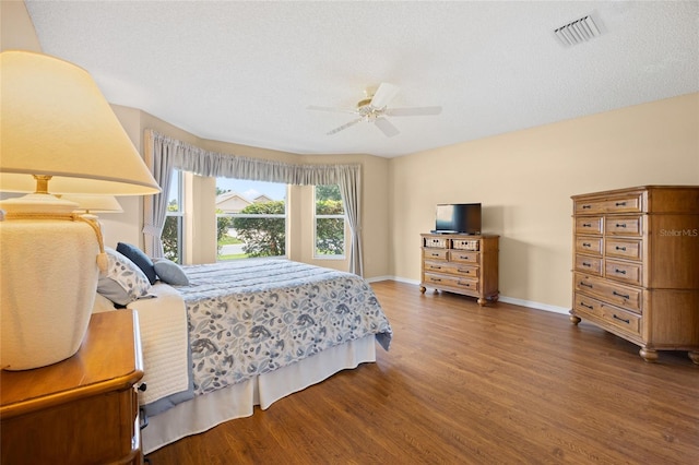 bedroom with wood finished floors, baseboards, and a ceiling fan