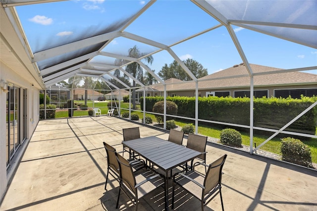 sunroom / solarium featuring vaulted ceiling and outdoor dining space