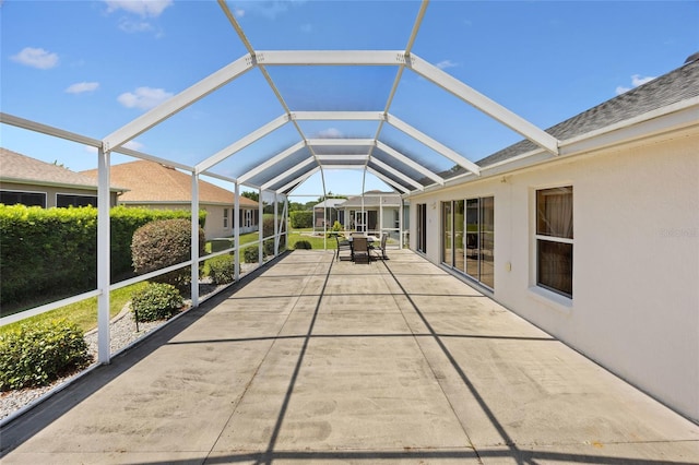 unfurnished sunroom with vaulted ceiling and outdoor dining space