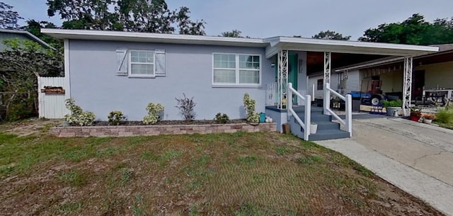 view of front of home featuring stucco siding and an attached carport