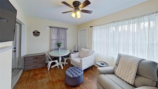 sitting room featuring wood finished floors and a ceiling fan