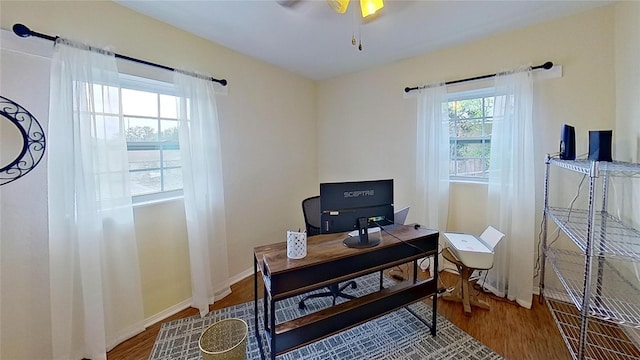 office space featuring wood finished floors, ceiling fan, and baseboards