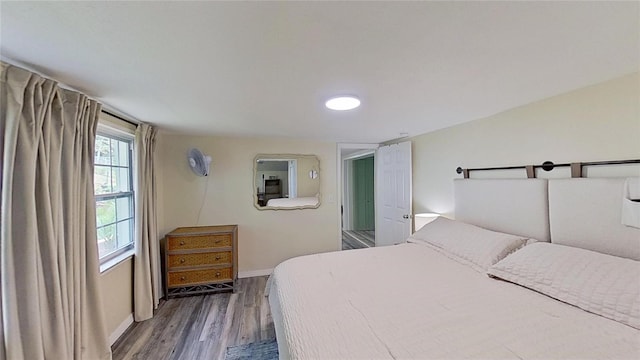 bedroom with wood finished floors and baseboards