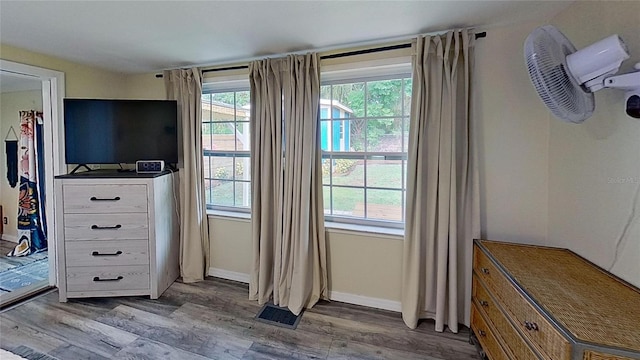 bedroom with wood finished floors and baseboards