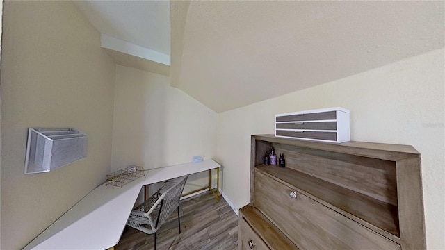 home office featuring vaulted ceiling and wood finished floors