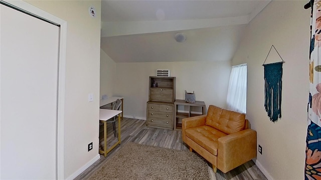 sitting room featuring vaulted ceiling, wood finished floors, and baseboards