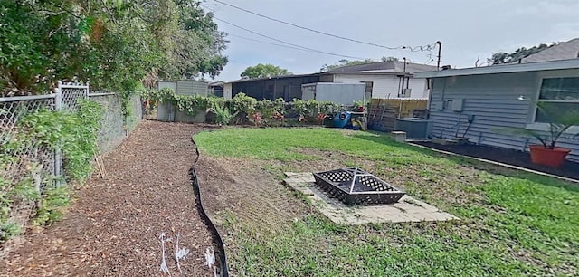 view of yard with an outdoor fire pit