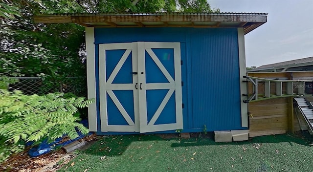 view of shed featuring fence
